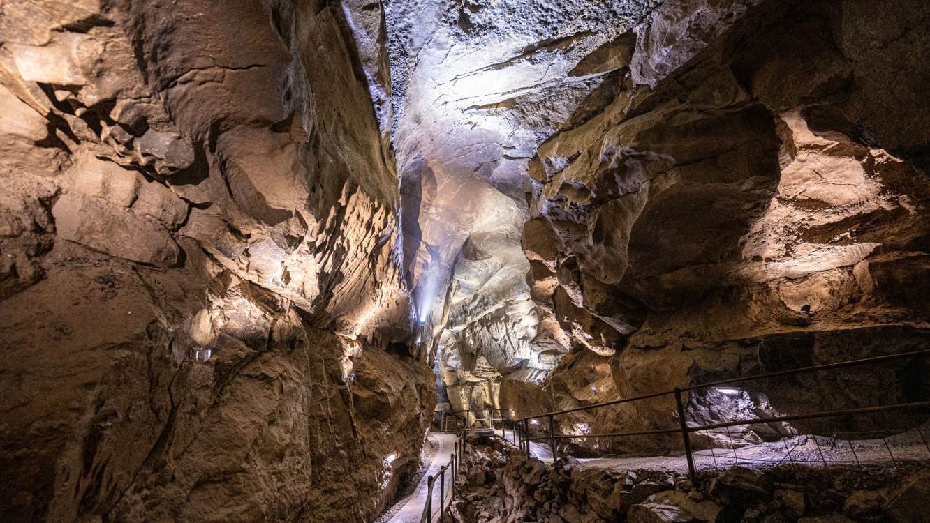 The interior of the limestone cave showing the metal railed walkway that visitors can walk along