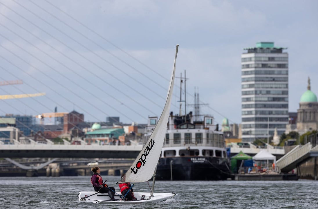 A dingy on the water with a city view in the background