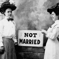 Two young women holding a sign that says 'Not Married'