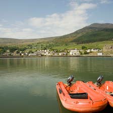 Two orange boats on the water on Carlingford Lough in Louth