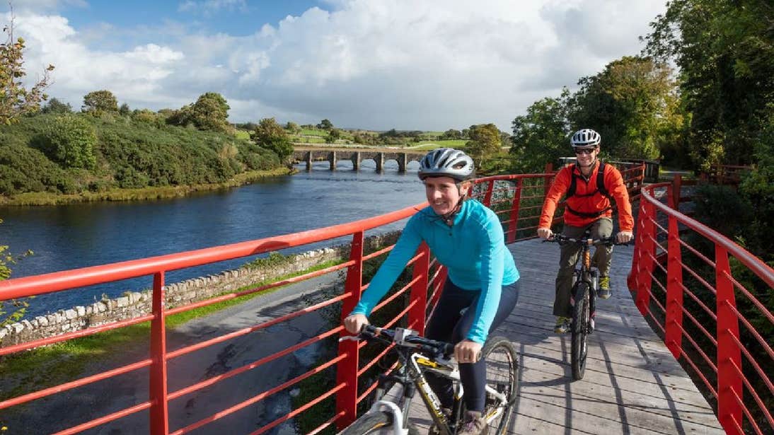 Cycle on a red bridge the Great Western Greenway in County Mayo