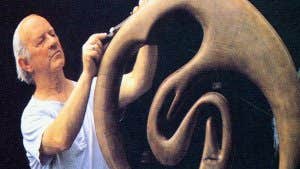 A sculptor working on a bogoak sculpture