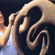 A sculptor working on a bogoak sculpture