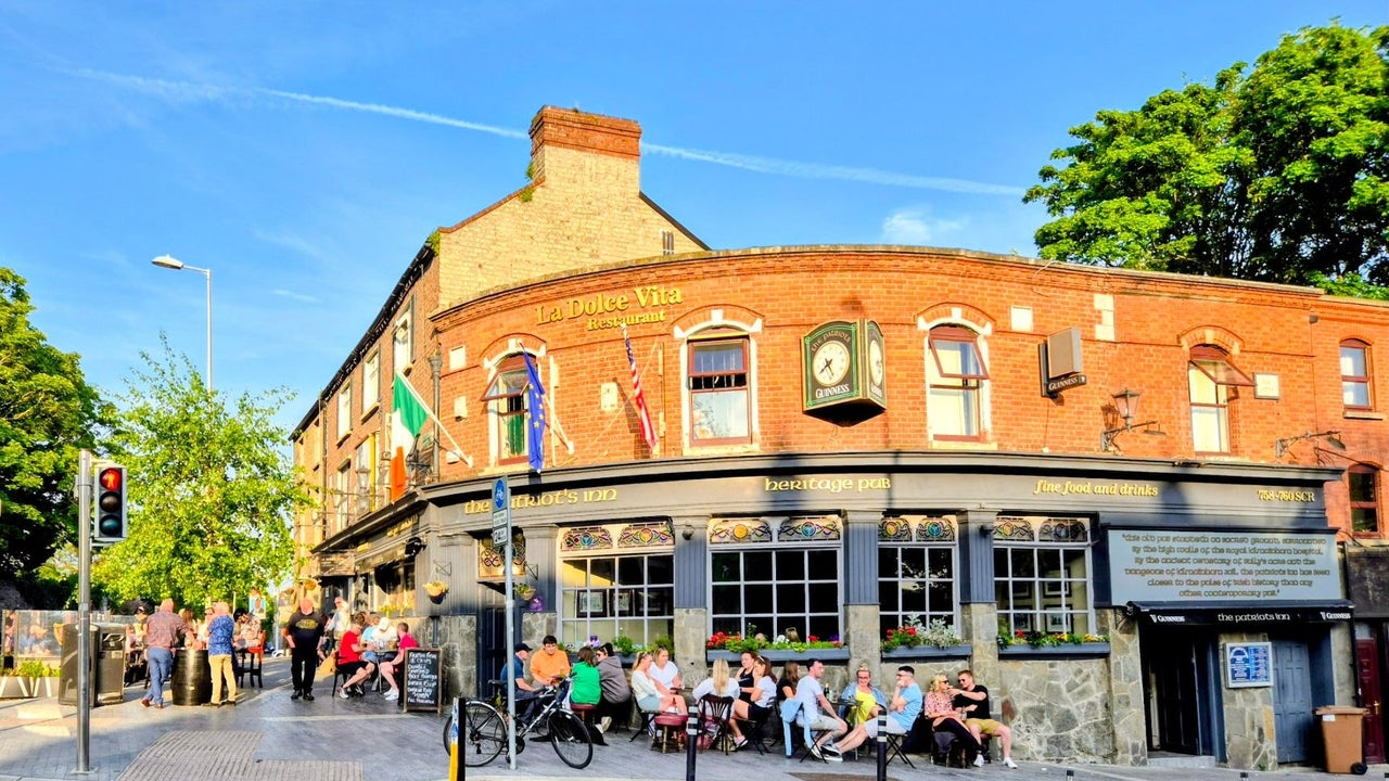 An image of the exterior of The Patriot's Inn with people sitting outside