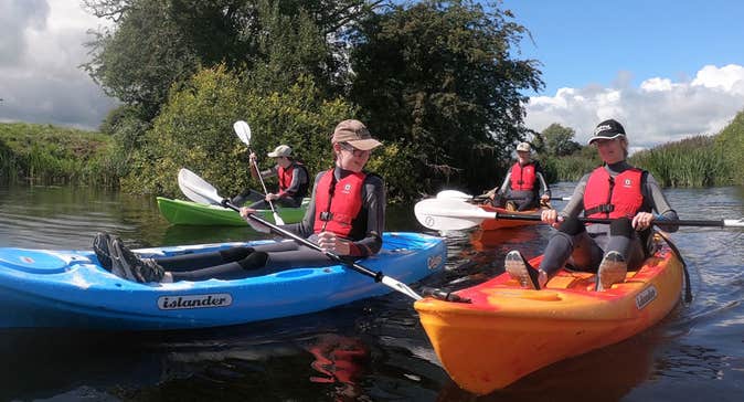 A group of people enjoying a kayak on the river on a sunny day