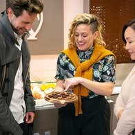 A tour guide showing a group of people gourmet chocolates while on the Galway Food Tour.