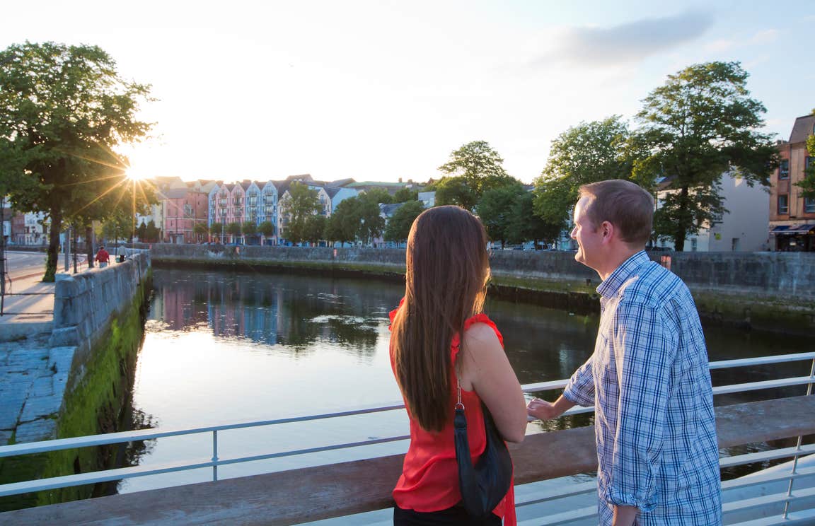 A couple looking out over the river in Cork City.