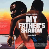 On a film poster, a man is carrying his son on his back.