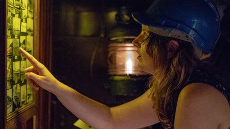 A lady looking at clues at Escape Boats