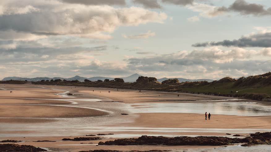 People walking on the Velvet Strand in Portmarnock, County Dublin