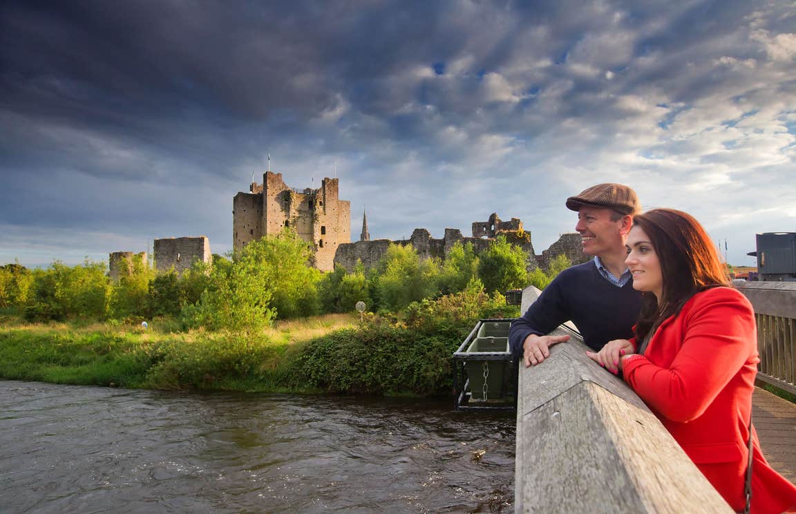 A couple on a bridge by the River Boyne at Trim Castle, Meath