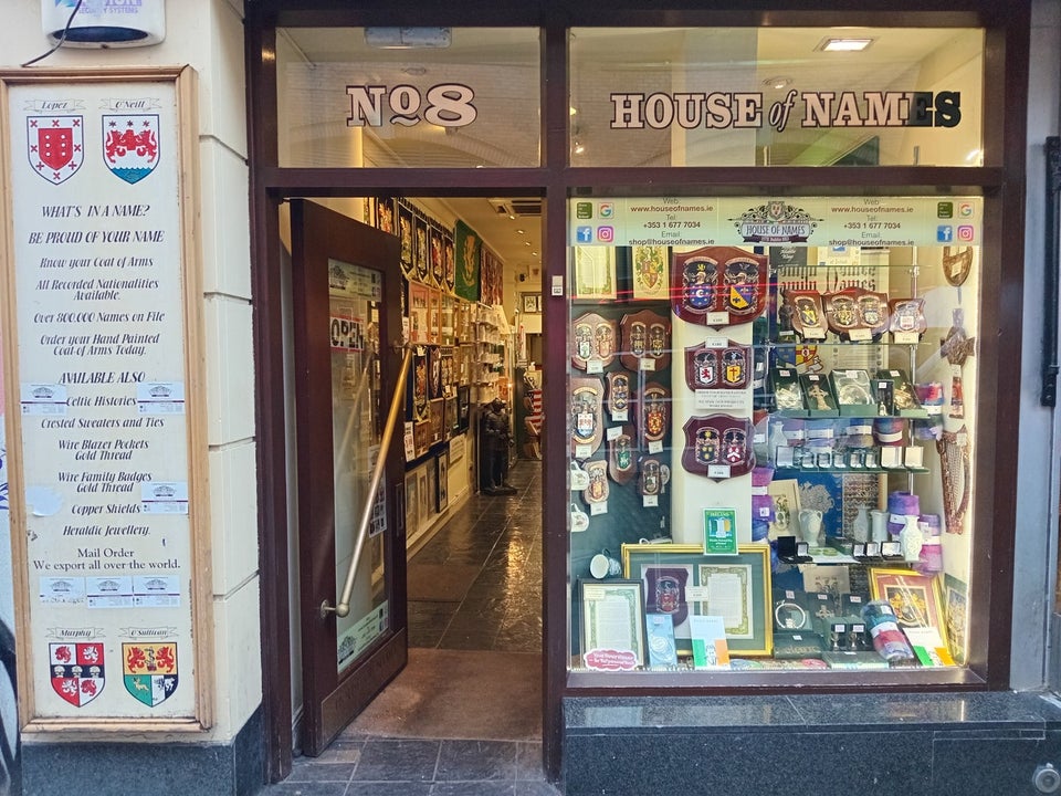 Exterior of a shop with lots of heraldic items on display at the window