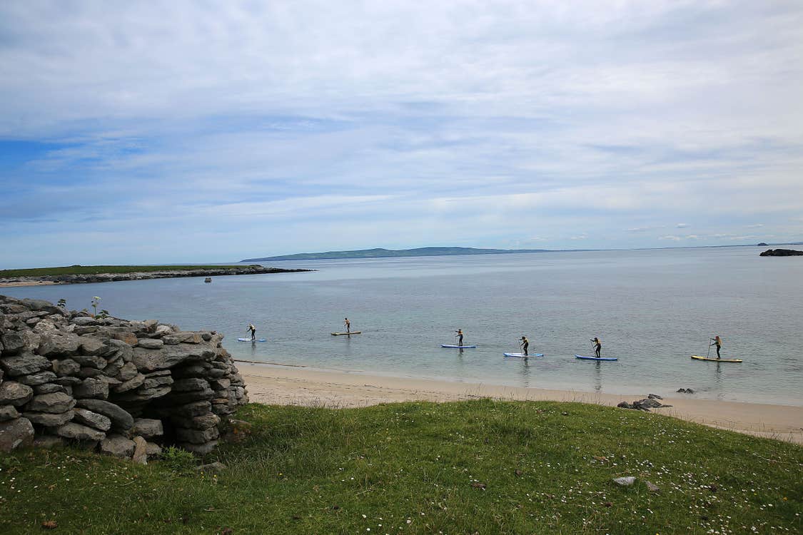 Six people paddle boarding at Castlegregory Beach in County Kerry.