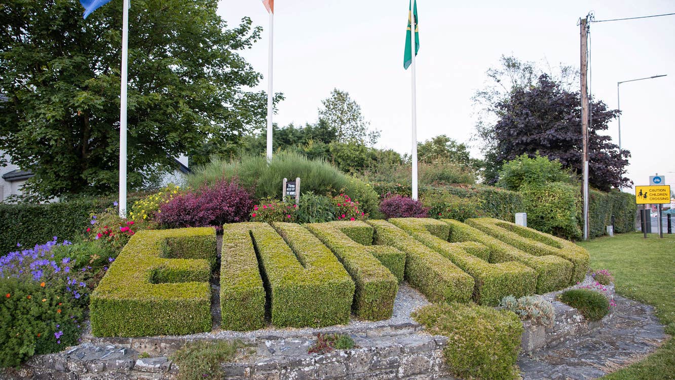 The word Enfield spelled out as a hedge in shrubbery as you enter town