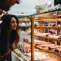 Woman looking at display of baked goods
