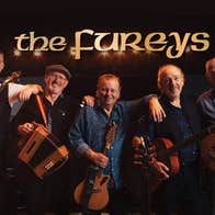 A line of 5 smiling older men with musical instruments