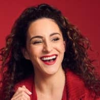 Janine Harouni with This is What You Waited For Tour, a laughing woman in red shirt.