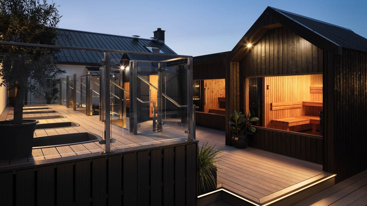 Lit saunas on a roof top at dusk