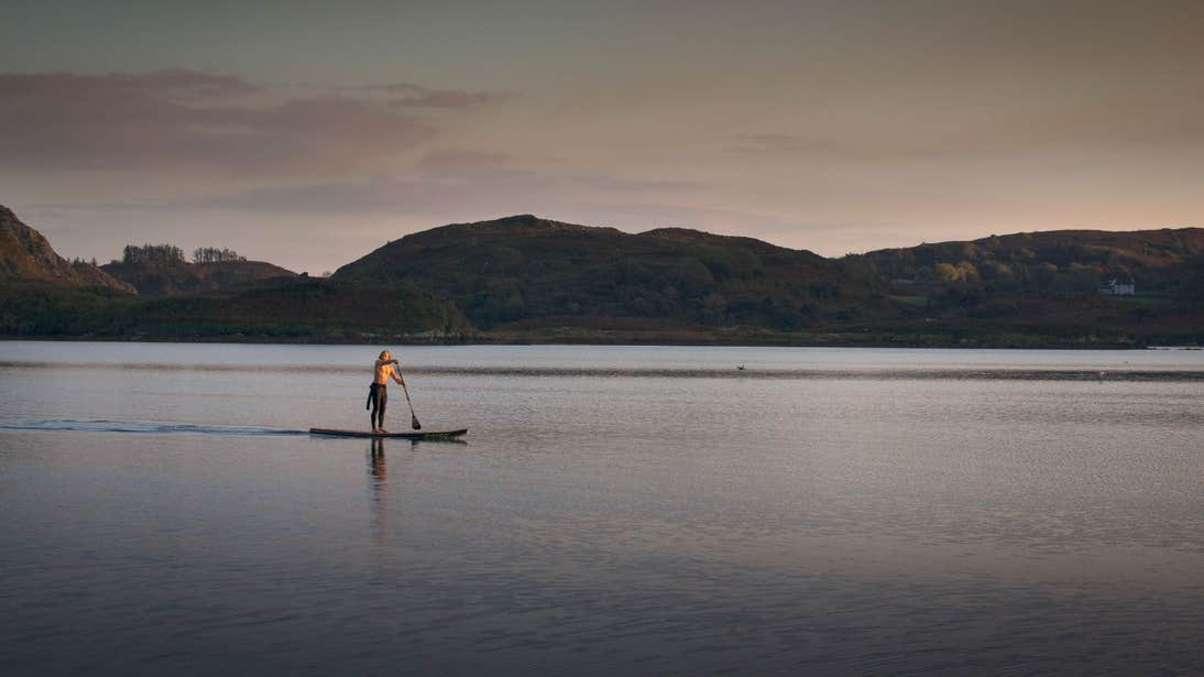 A person Sup on Lough Hyne at sunset