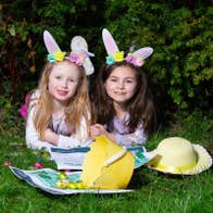 Easter Trail Strokestown Park, 2 young girls laid on grass with easter bunny ears, baskets and eggs