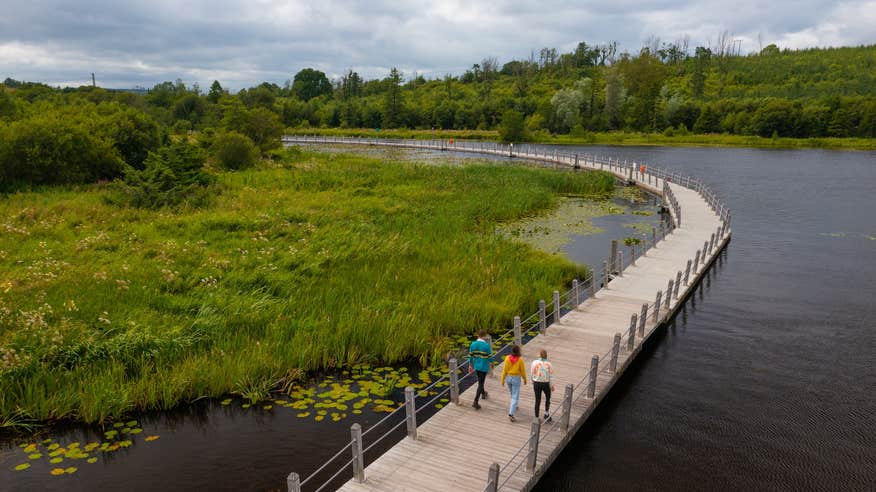 People walking the Acres Lake Floating Boardwalk in Co Leitrim