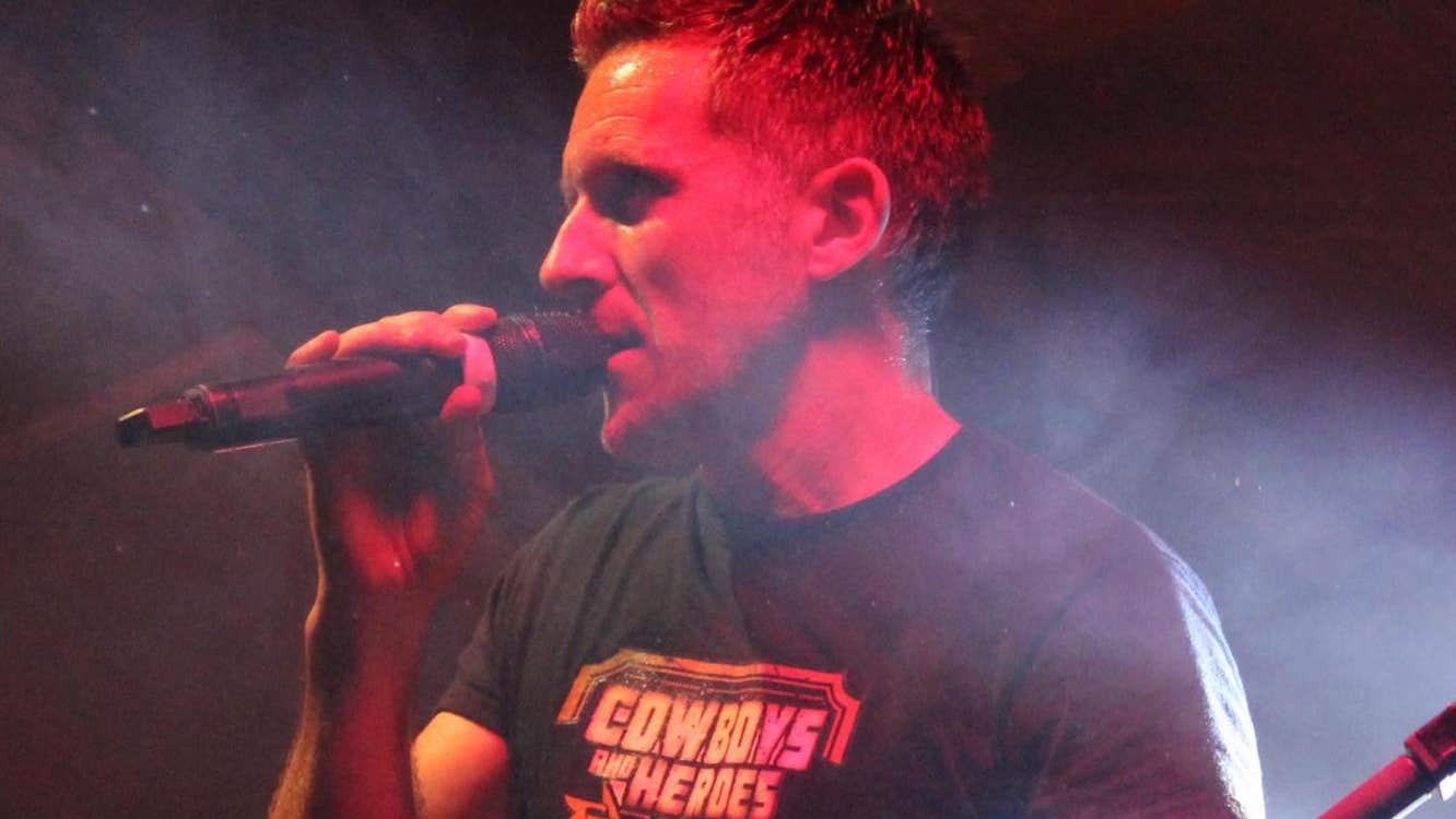 Competition time at Cowboys and Heroes, Drumcoura, a man singing into a hand held mic.