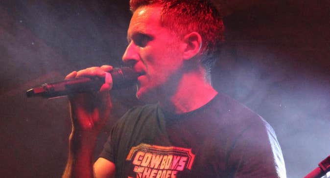 Competition time at Cowboys and Heroes, Drumcoura, a man singing into a hand held mic.