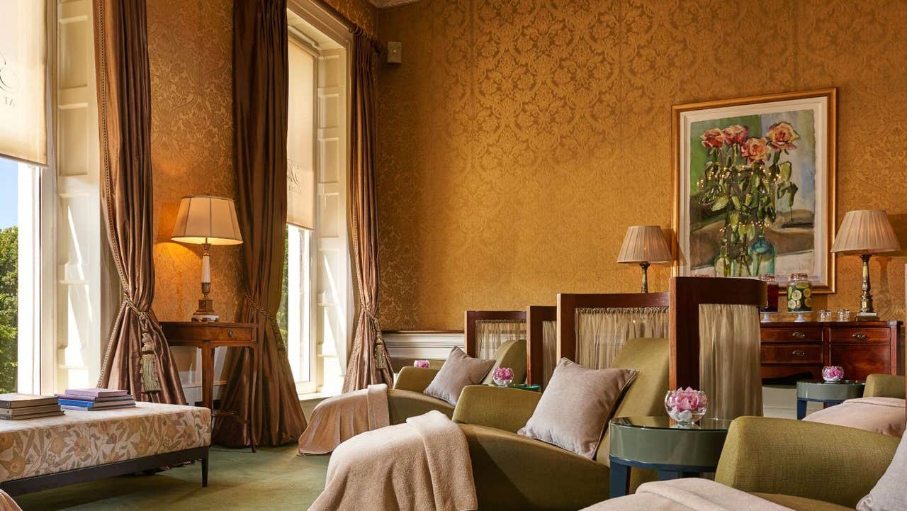 Three spa beds with blankets and cushions in a relaxation room