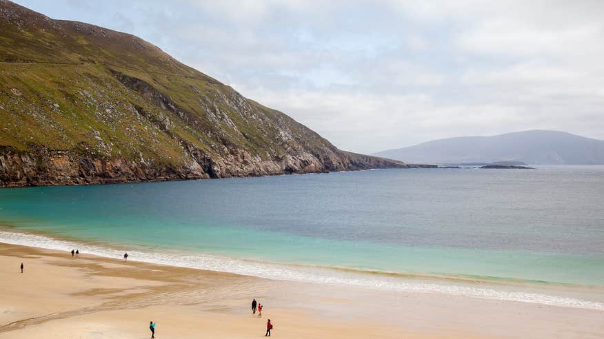 People on Keem Bay beach on Achill Island in Mayo