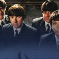 4 men in suits and ties and beatle hair cuts