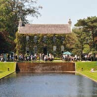 Festival of Gardens & Nature 2026, view across a man made square pond looking at an old house in the distance.