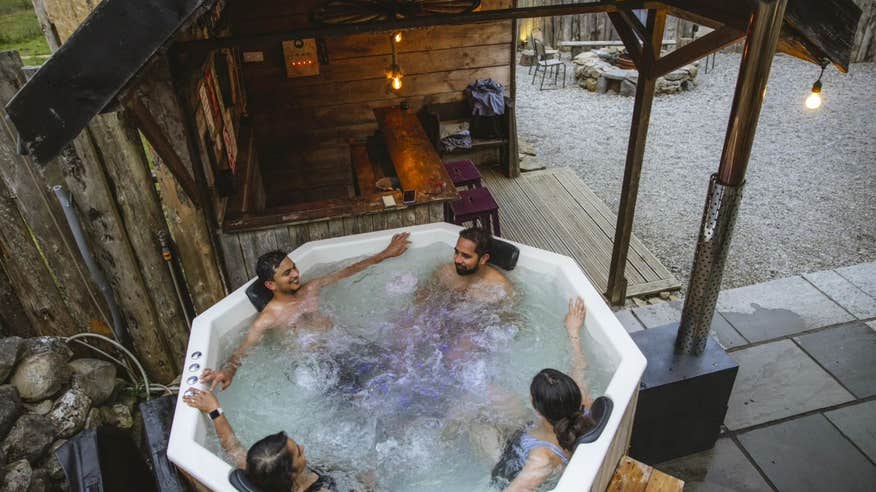 Four people in a hot tub at Mayo Glamping in County Mayo