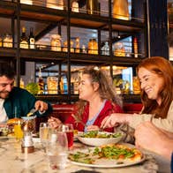 Four people enjoying a meal.
