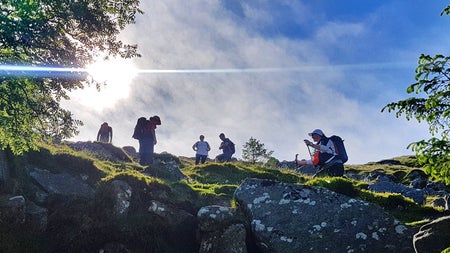 A group of walkers navigating their way along a rocky ridge