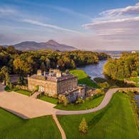 An aerial view of a large period house with an extensive garden