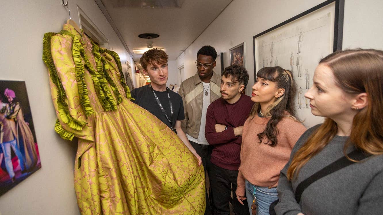 People looking at a costume dress backstage with Abbey Theatre Tours