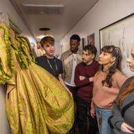 People looking at a costume dress backstage with Abbey Theatre Tours