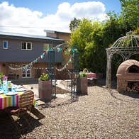 A courtyard set up with a table for outdoors eating.