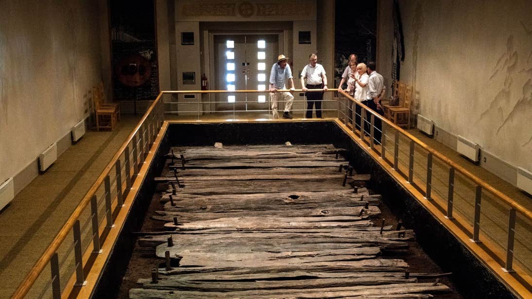 A group of people looking at a display of Corlea Trackway, Longford