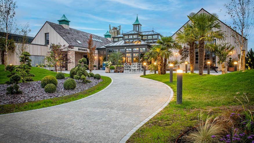 Entrance into The Shed Distillery in Drumshanbo Co Leitrim. The entrance is lined with nicely kept gardens and lights.