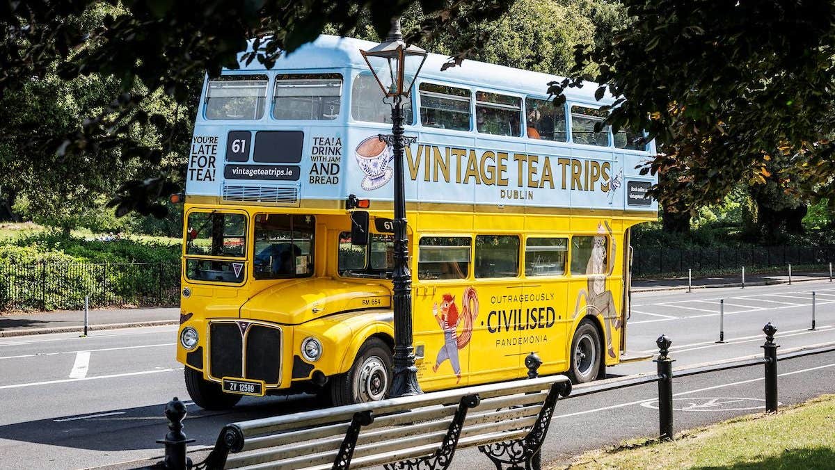 A yellow and blue vintage double decker bus