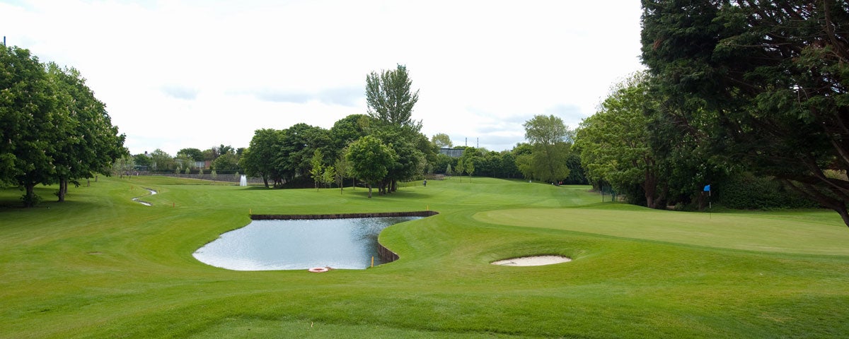 View of 13th and 14th fairways with pond in the centre and small bunker to the right