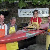 People holding up a woman in a kayak at Lough Derg Watersports