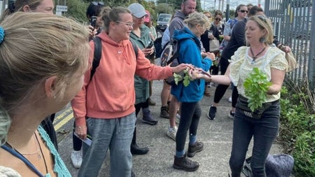 Guide handing out foraging produce