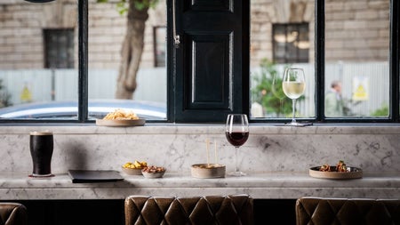 Long counter area prepared for dining with a view of a city street