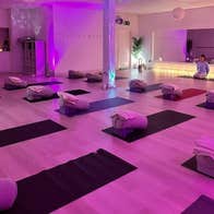 Studio set up for a yoga class with mats and blankets