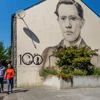 People walking past the Francis Ledwidge mural in Slane, Co Meath