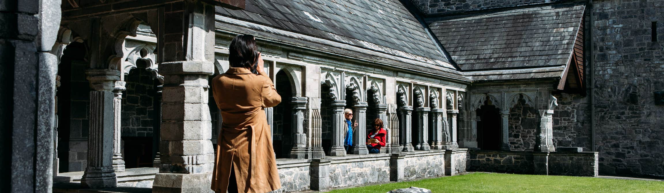 Woman taking a photo at Holycross Abbey.