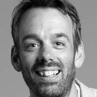 The head and shoulders of Chris Finnegan. He is smiling.