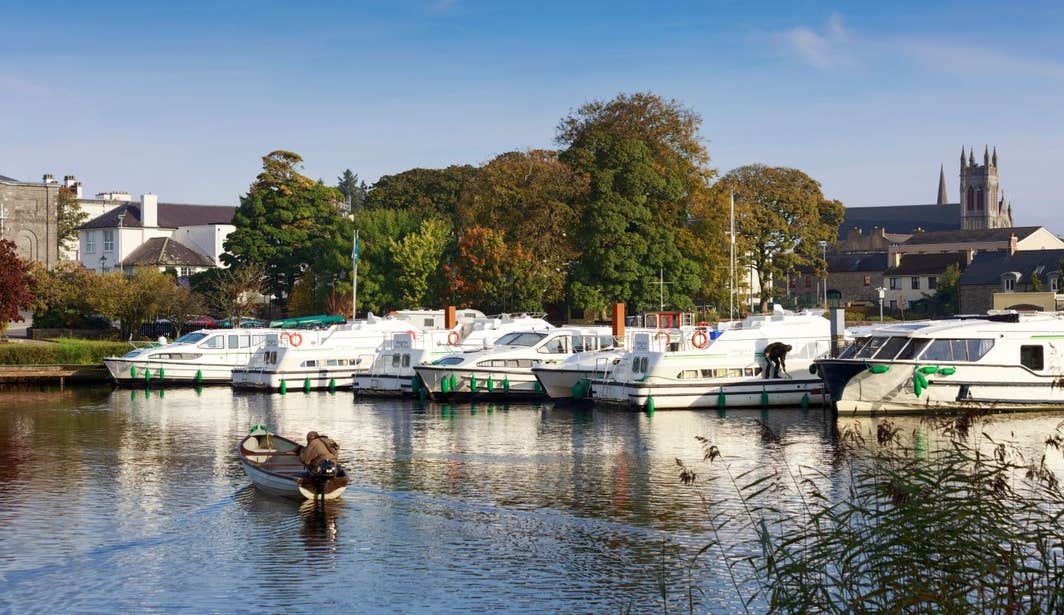 A small boat approaching bigger boats at Carrick-on-Shannon Marina, Co. Leitrim